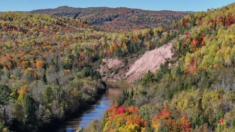 Cliffside with River Running through Autumn Colors Drone Stock Footage 315265314