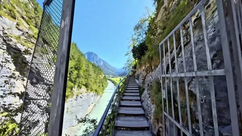 Cliffside Stairs Along Turquoise River in Narrow Alpine Gorge Stock Footage 344878287