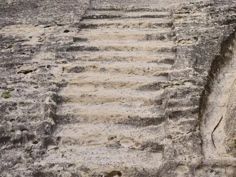 Cliffside trail adventure, Eroded step pathway borders cliff with shadowed .. 写真素材