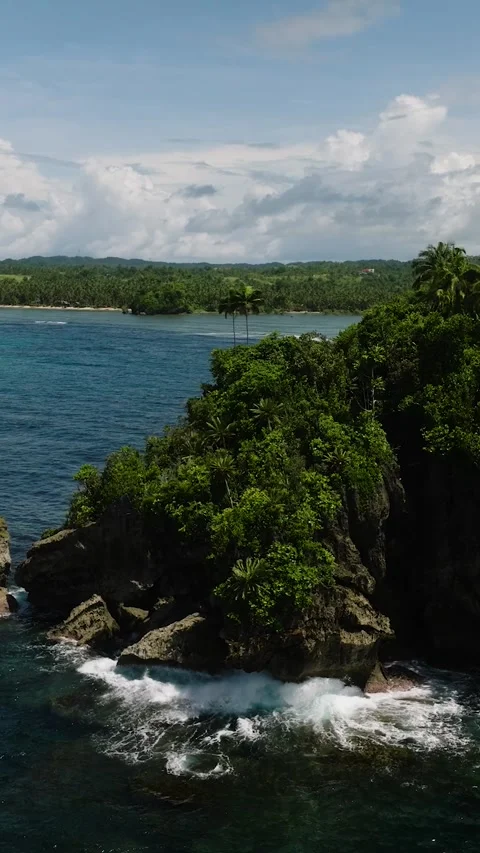 Cliffside tropical forest above blue ocean water. Siargao, Philippines. Stock Footage 324847021