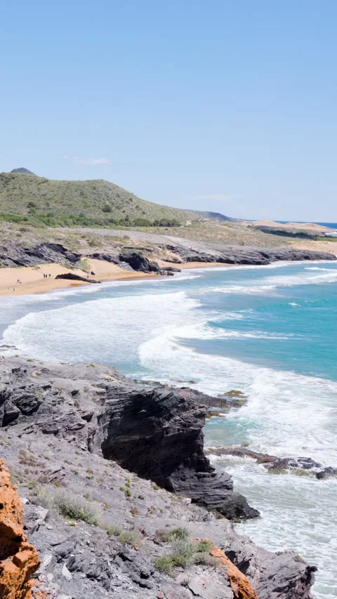 Cliffside view of Calblanque beach with rocky shoreline Stock Footage 308469769