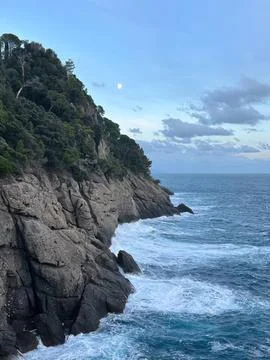 Cliffside view of ocean waves crashing against rocky shore Stock Photos