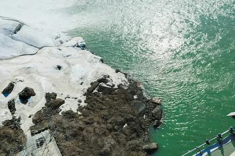 Cliffside view of ocean waves crashing on rocky coast Stock Photos