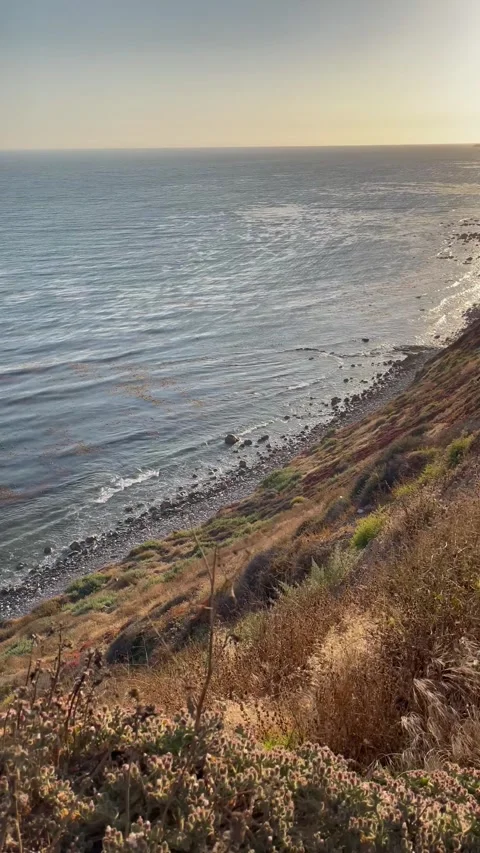 Cliffside View Pacific Ocean at Sunset Blue Skies &amp; Beach Waves Stock Footage 244814736