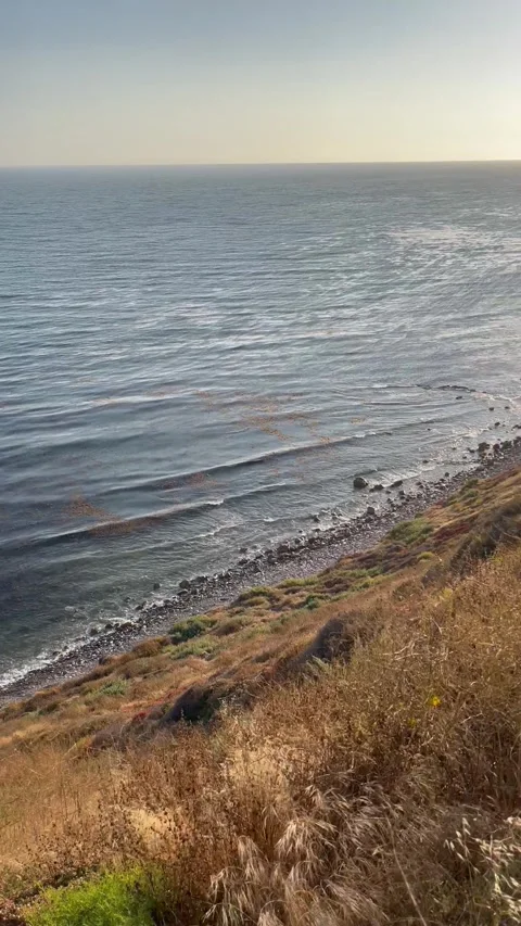 Cliffside View Pacific Ocean at Sunset Blue Skies and Beach Waves Stock Footage 244814738
