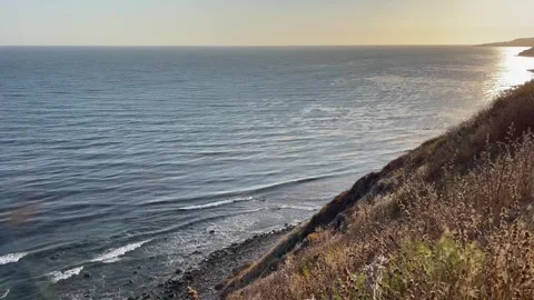 Cliffside View Pacific Ocean at Sunset Blue Skies and Beach Waves Stock Footage 244814773
