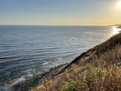 Cliffside View Pacific Ocean at Sunset Blue Skies &amp; Beach Waves Stock Photos