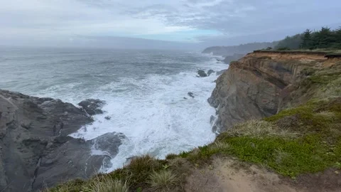 Clifftop view of churning waves of the Pacific Ocean on the Oregon Coast Stock Footage 329448785
