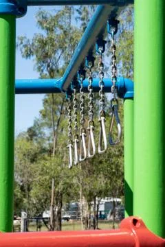 Clilds swinging monkey bars Stock Photos