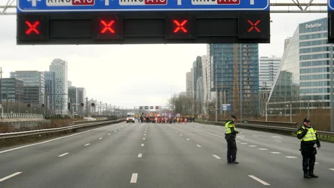 Climate activist group protest marching on highway. Amsterdam, Netherlands. Stock Footage 266169268
