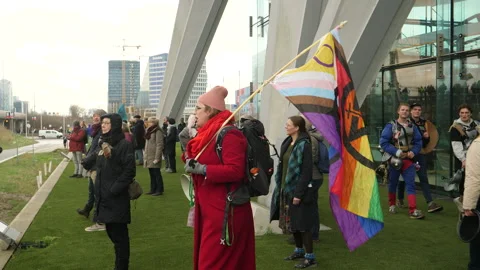 Climate activist with megaphone addressing crowd. Pan activist man to crowd. Ams 스톡 동영상 266546988
