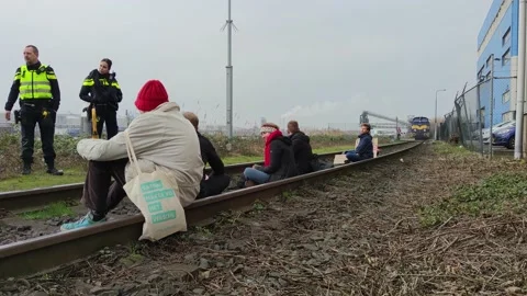 Climate activists blocking the rail tracks used for coal transportation Stock Footage 233883126