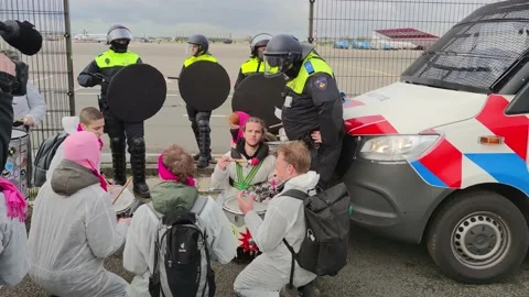Climate activists drumming during protest against the Schiphol Airport expansion Stock Footage 220629015