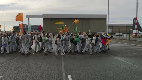 Climate activists marching towards the airport terrain during massive protest Stock Footage