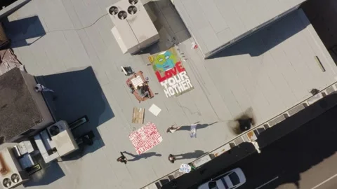 Climate Activists Painting Rooftop Protest Banners, Top Down Aerial Stock Footage 345397356