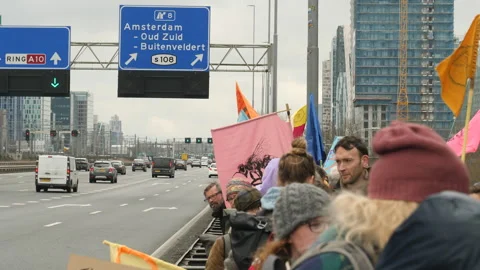 Climate activists by side of the road just before road block protest. Amsterdam, Stock Footage 266546790