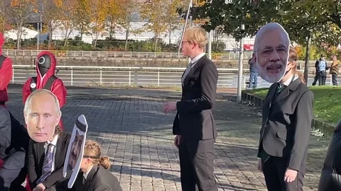 Climate activists stage protest posed as world leaders in Squid Game Stock Footage 164298600