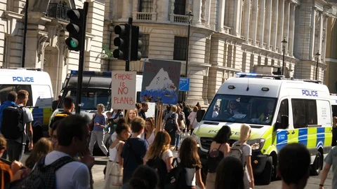 Climate Change Angry Protesters March towards Police Officers inside van Stock Footage 116363952