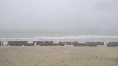 Climate change concept view of heavy storm and wind blowing white sand beac.. Video stock 326625721