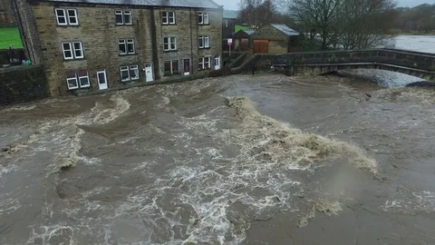 Climate change,  dramatic flooded river at Brearley near Hebden Bridge Stock Footage 76982808