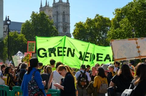 Climate Change protesters holding protest banners with Westminster Abbey in t Stock Photos