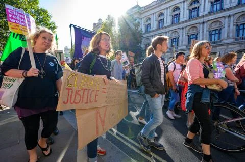 Climate Change protesters marching and holding placards at an Extinction Rebe Stock Photos