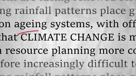 Climate Change Text on Simulated News Article with Crumpled Paper Background Stock Footage 343395627