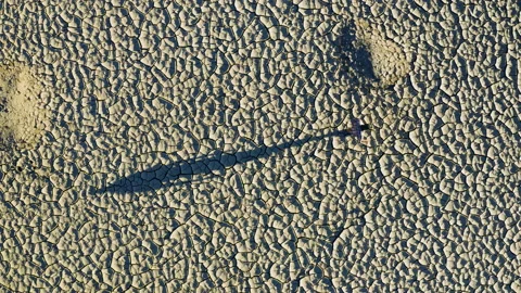 Climate change.Aerial view of a devastated farmer walking across day dam Stock Footage 155728575