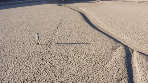 Climate change,global warming,drought.devastated farmer walking across dry dam Video stock 104536039