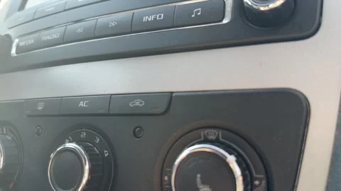 Climate control knob rotates to change airflow direction inside a car, cabin Stockbeeldmateriaal 337115040