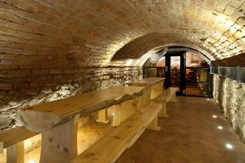 Climate controlled wine cellar, with a domed brick ceiling and walls, stacked Fotos de archivo