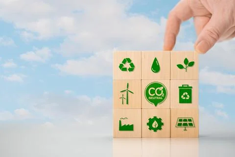 Climate neutral long term strategy. Hand put wooden cubes with green icon and Stock Photos