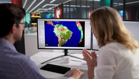 Climate Scientist Studies Global Warming On Computer Screen In Office. Stock Photos