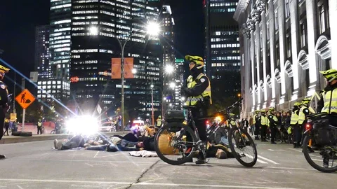 Climate strike activist laying down on the street Stock Footage 120062139