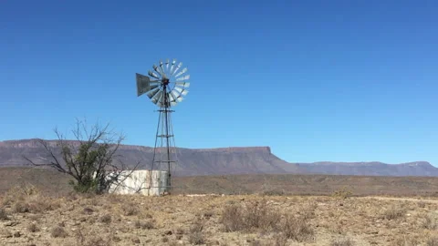 Climax wind pump windmill spinning in South Africa Wide Shot Stock Footage 145741539