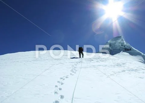 The climb on snowy peak Stock Photos