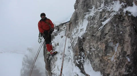 Climber abseiling back down using a double rope.  Dolomiti (East Alps), Stock Footage 34448694