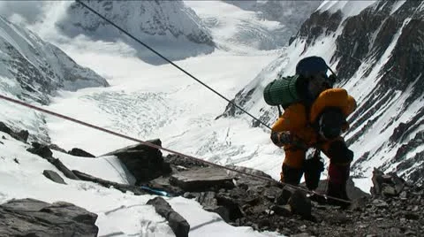 Climber ascending rocky patch on ropes Stock Footage 22220836