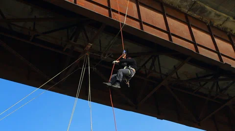 Climber is attached to the bridge Stock Footage 38041454