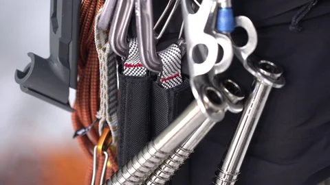 Climber attaching hiking tool in harness while climbing Stock Footage 73621796