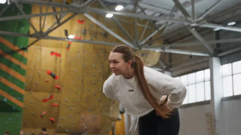 Climber with braid aims high. Casual dressed female climber practices mobility 動画素材 341767428