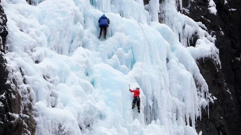 Climber breaks off glacier and hangs on belay rope and ice axes Stock Footage 88181278