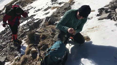 Climber changes the crampon at the Korab route in Macedonia. Stock Footage 156143525