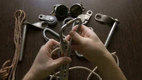 The climber checks the device for descent, before a hike, close-up Stock Footage 73580678