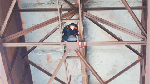 Climber checks reliability of fastening elements on the bridge Stock Footage 60440145