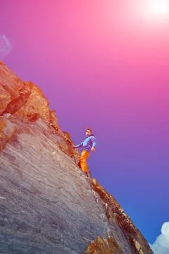 Climber climbing up a cliff Stock Photos