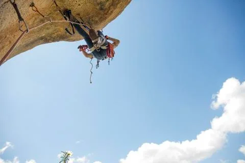 Climber climbing a rock using aid climbing techniques Stock Photos