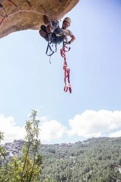 Climber climbing rock using aid climbing techniques Stock Photos