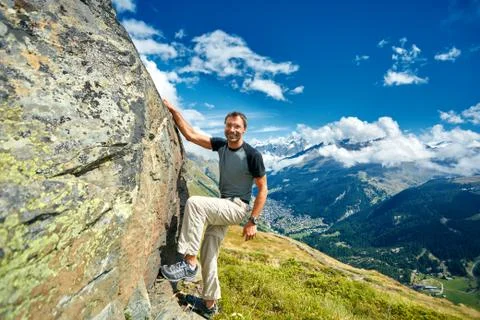 Climber climbing up a stone Stock Photos
