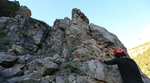 Climber climbing the top of the rock 8 Stock Footage 24223494